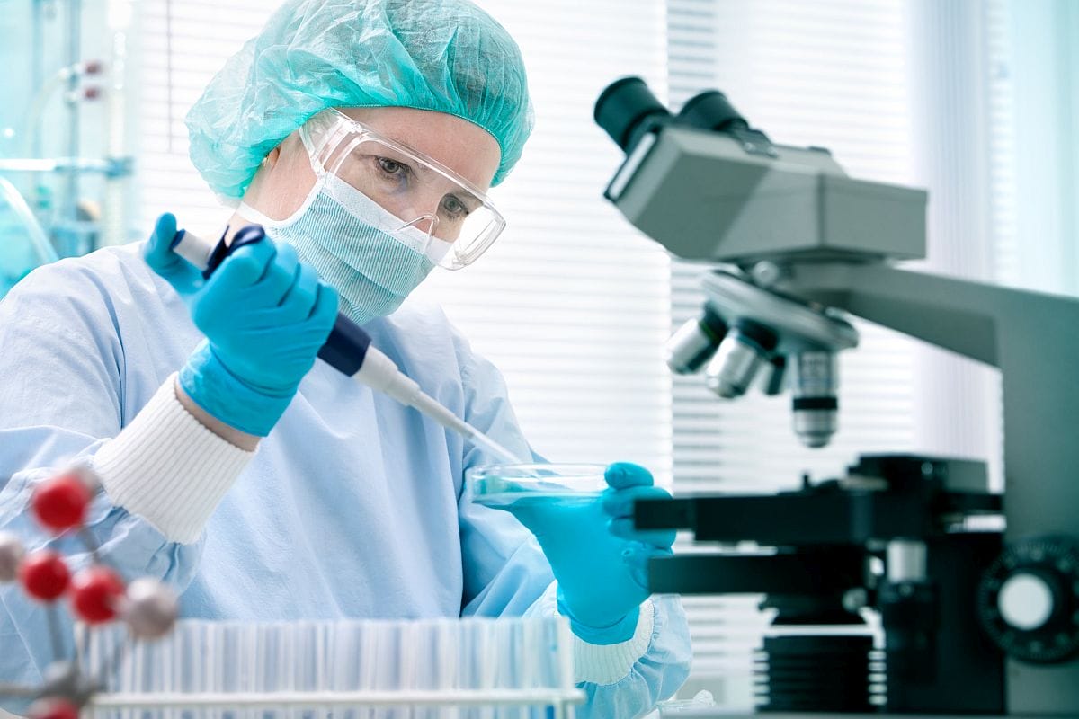 Healthcare professional working in lab; payer systems concept