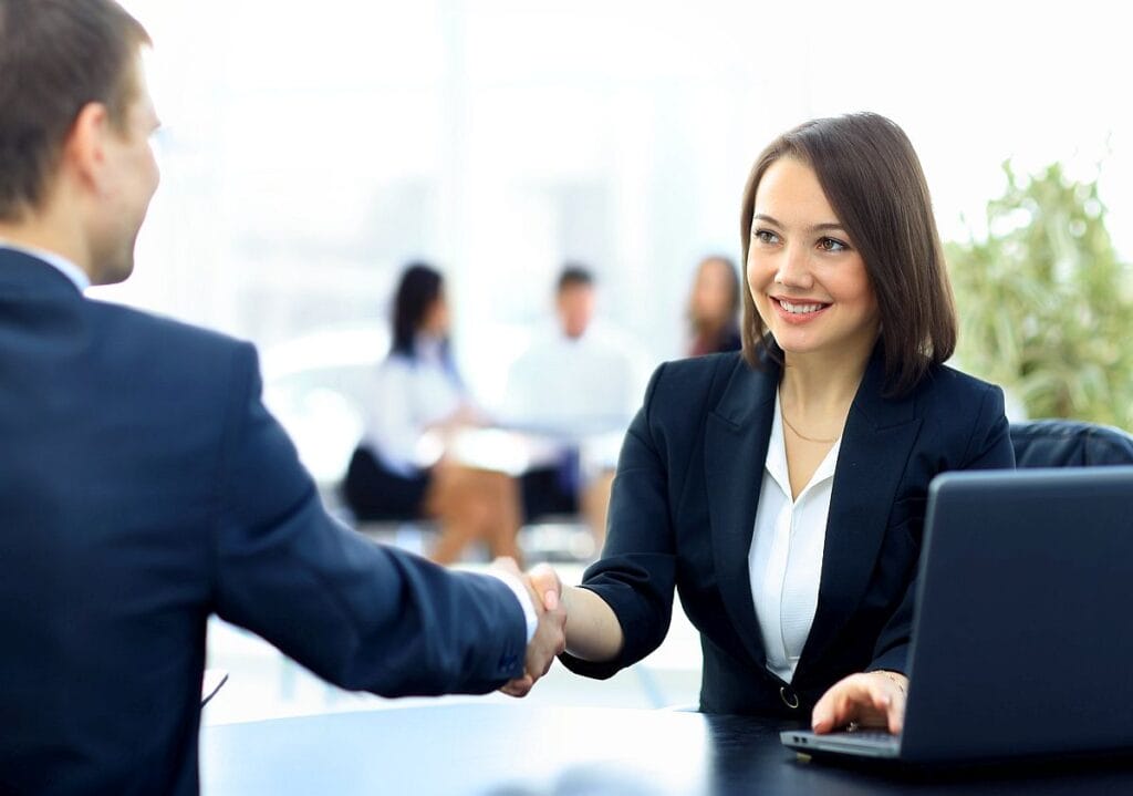 Two professionals shaking hands; patient care coordinators concept