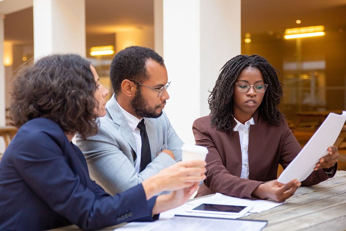 Three professionals in discussion; value of rare disease therapies concept