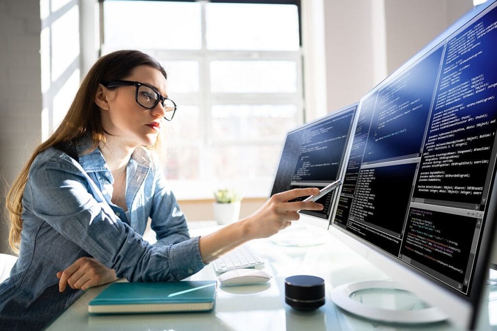 Professional woman working on computers; better economic models concept