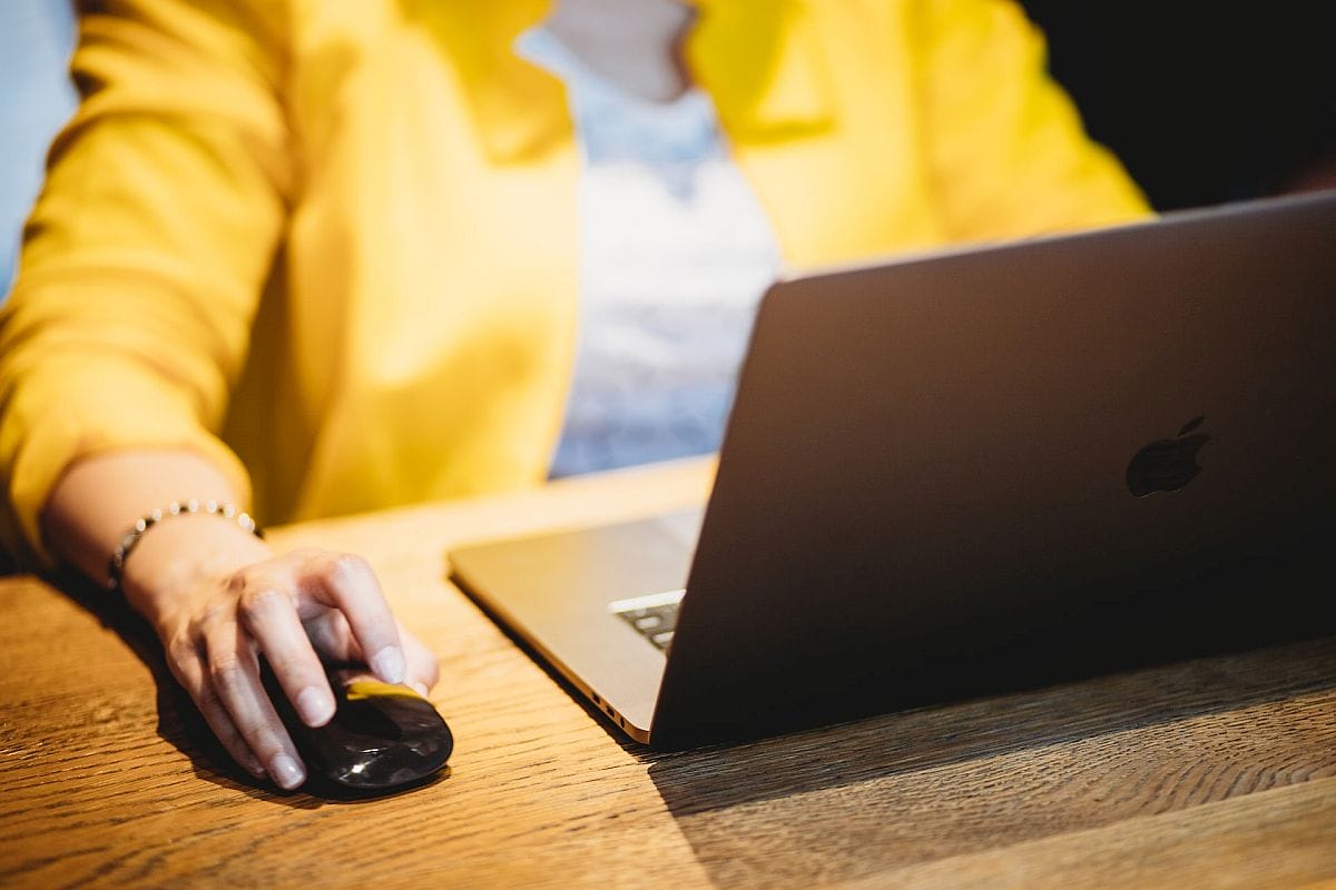 Close-up of woman working on laptop; centers of excellence concept