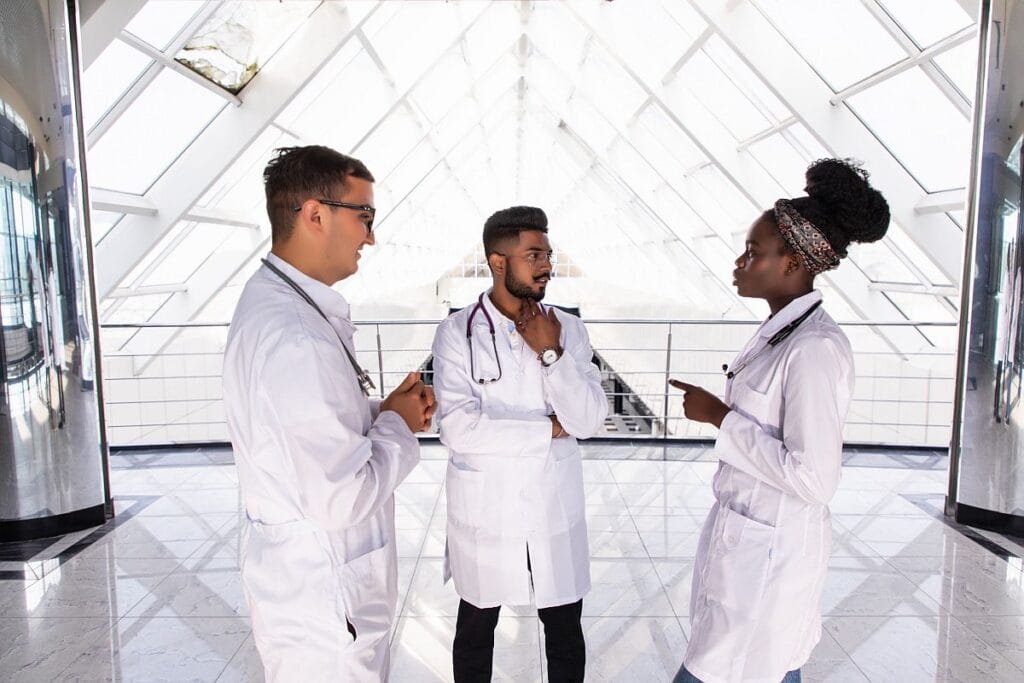 Three healthcare professionals having a discussion; patient data concept