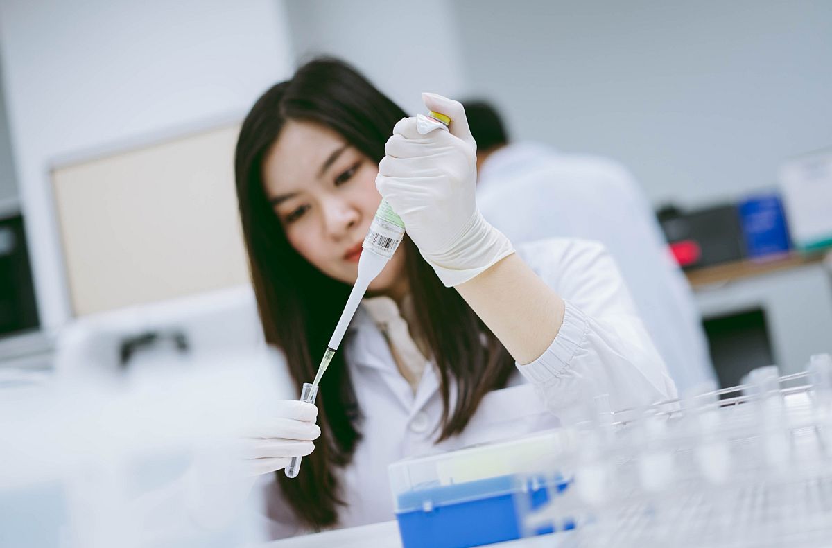 Lab tech working in medical laboratory; rare disease research concept