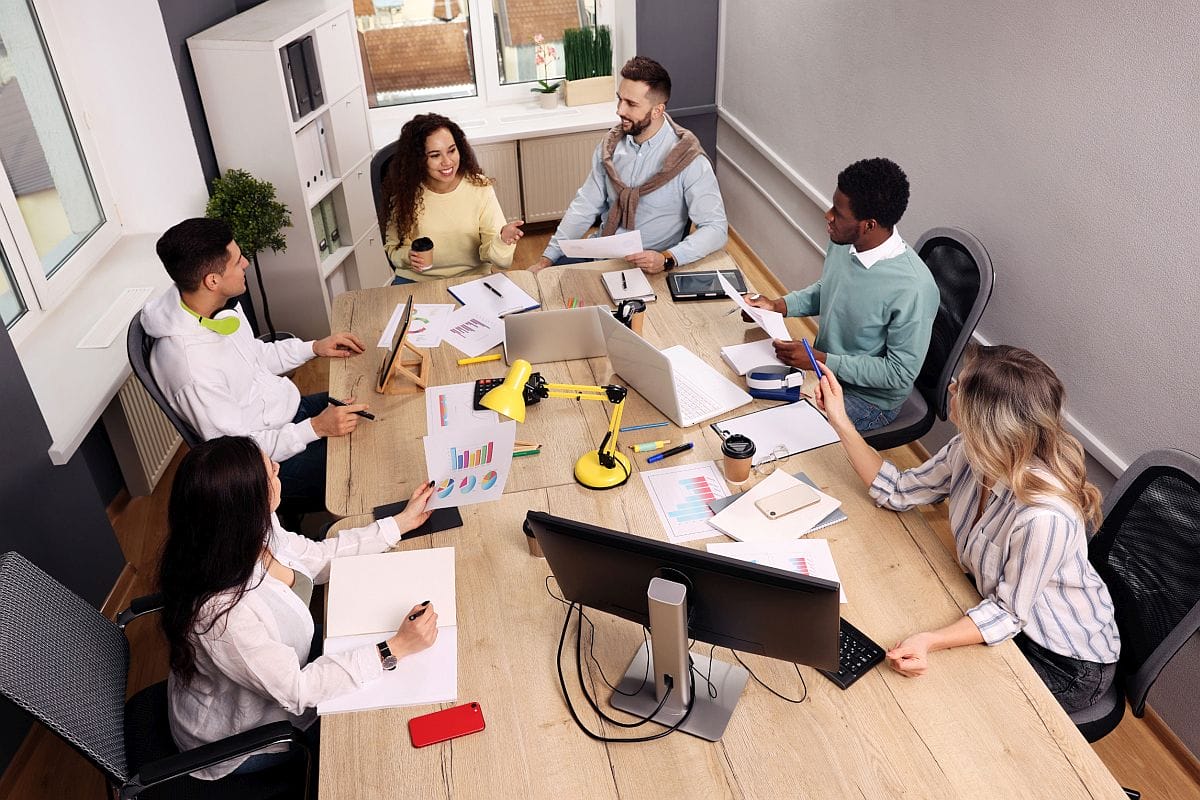 Business team meeting around a table; successful product launch concept