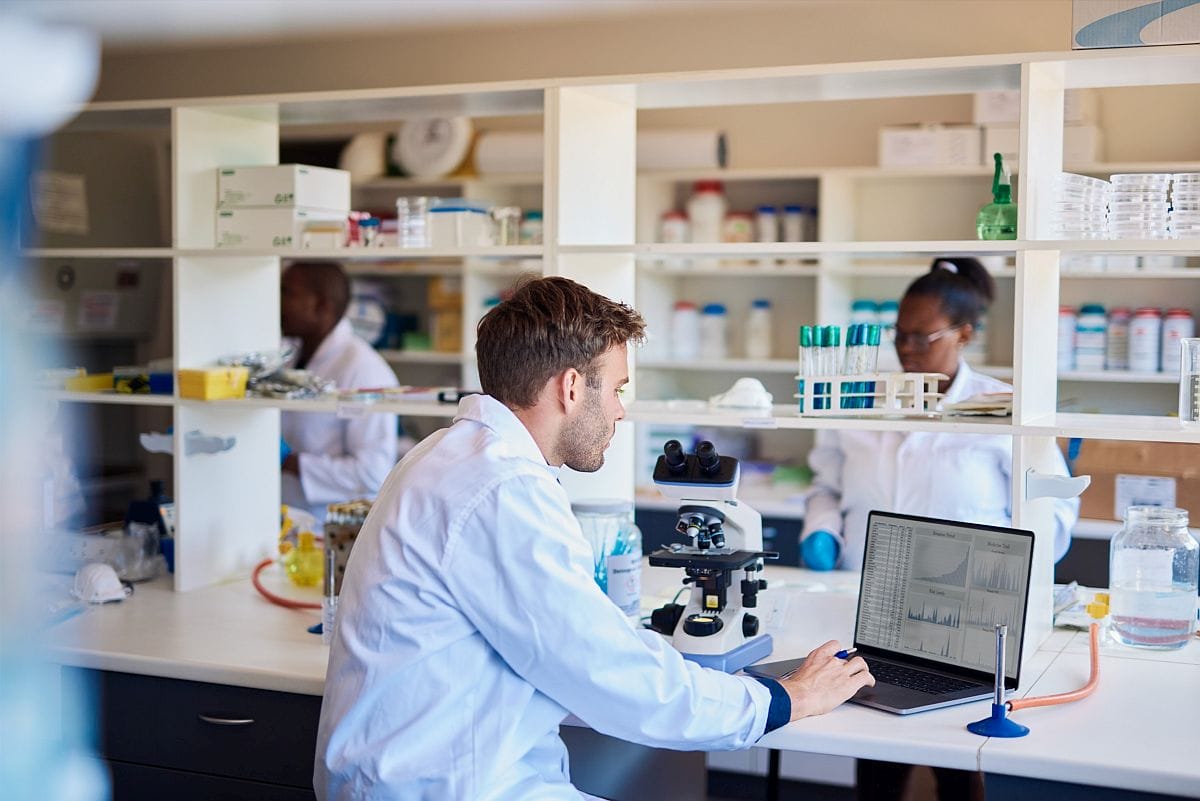 Lab technicians at work in laboratory; cost control concept