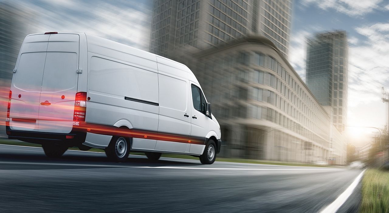 White van driving in the city; pharmaceutical supply chain concept