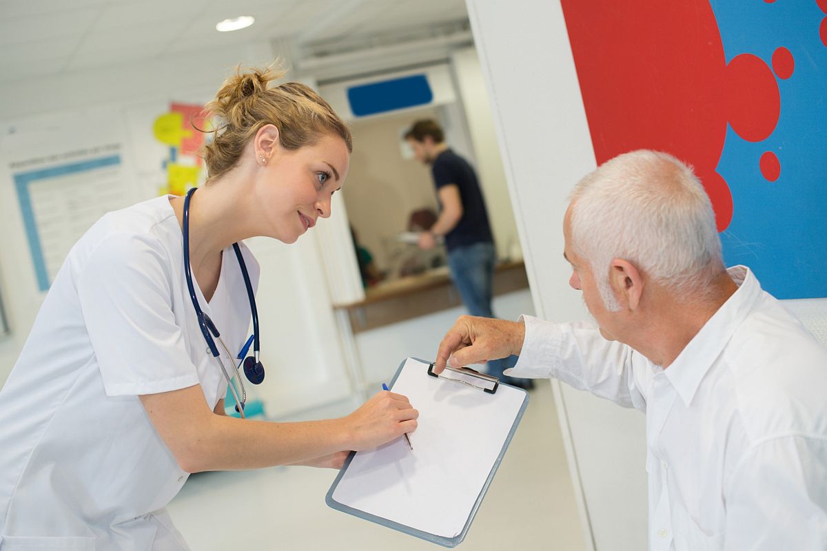 Healthcare worker giving patient document to sign; paid fill rate concept