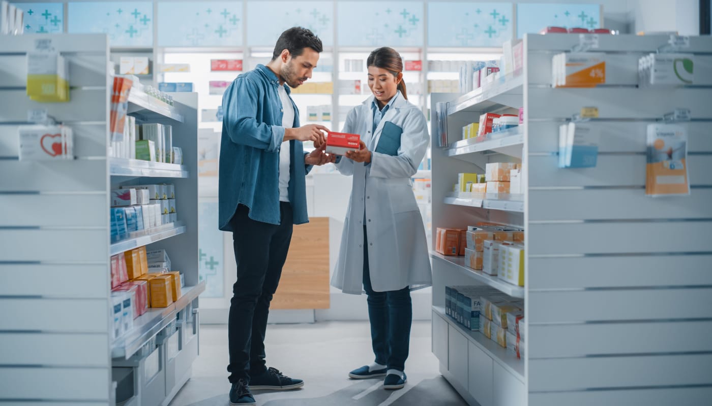 Pharmacist explaining medication to patient; Pharmacy Benefit Managers (PBMs) concept