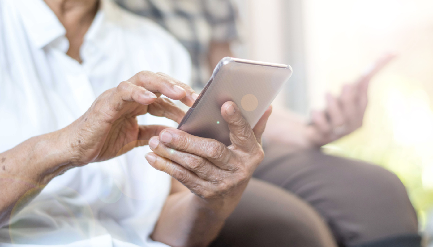 close-up of a person using a smartphone; Patient-Reported Outcomes concept