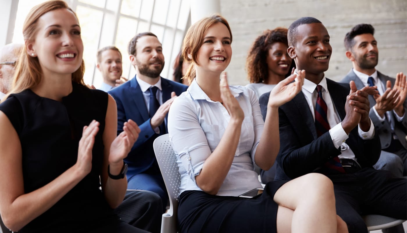 Professional audience applauding and smiling; National Association of Specialty Pharmacy Conference concept