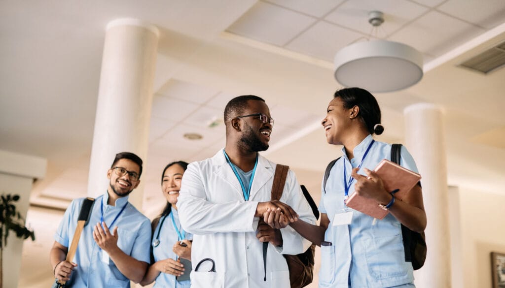 Smiling doctors and researchers shaking hands; gene therapy concept